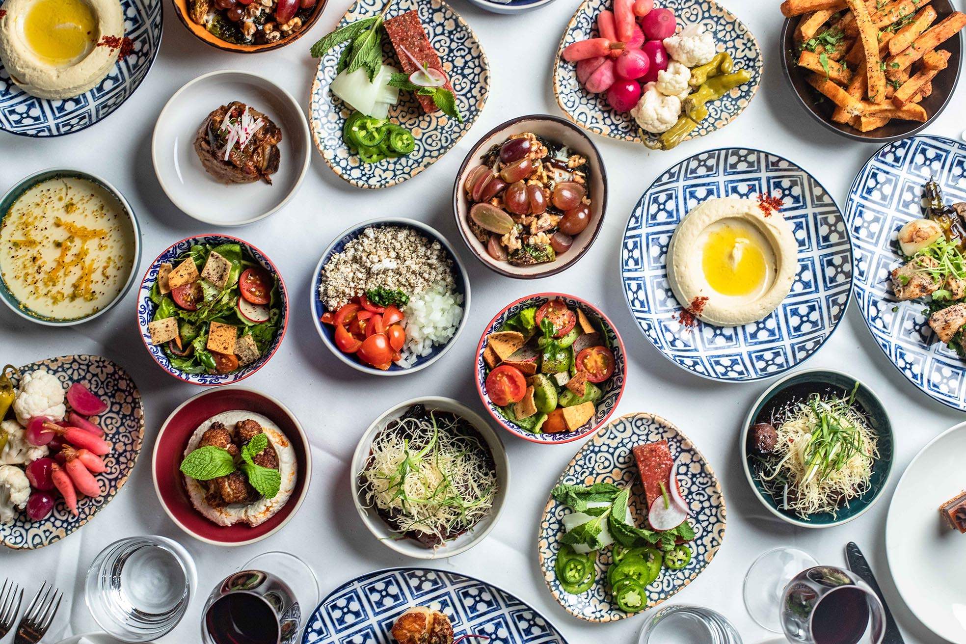 An array of colorful meze, or small plates at Ilili, a group-friendly Lebanese restaurant in NYC.