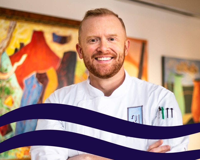 An image of chef Henry Johnson in a chef's coat with his arms folded