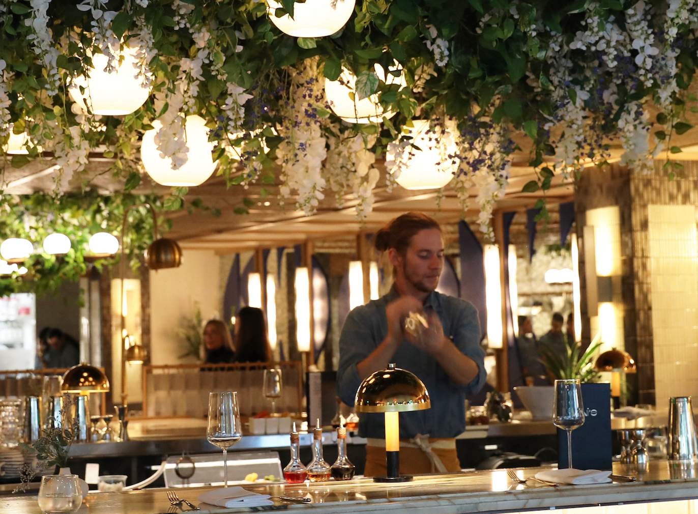 A bartender mixing a drink at the Denver Greek restaurant Kini's.