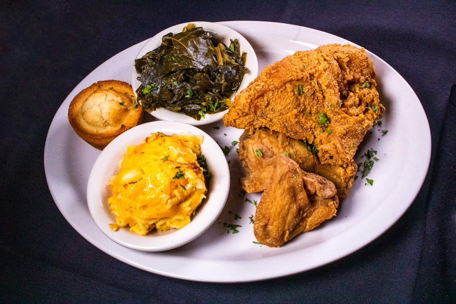 A fried chicken and green collards plate at Paschal's restaurant in Atlanta
