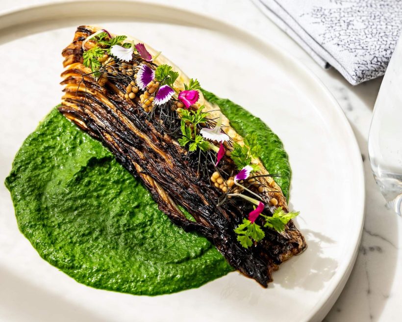A charred cabbage dish in a green sauce at Washington, D.C. restaurant Estuary
