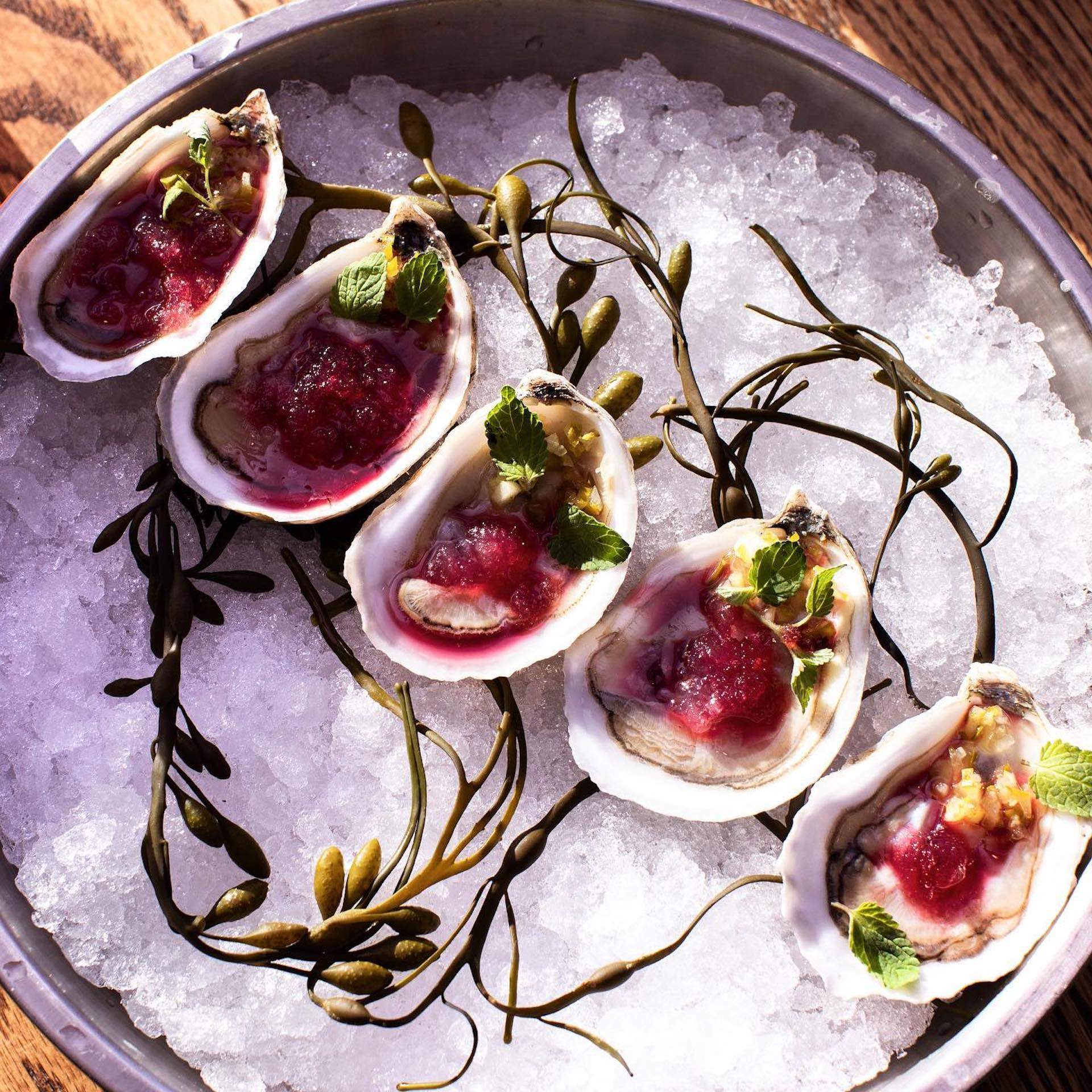 Five oysters placed in a line over ice at Banks Fish House in Boston