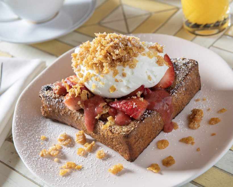 A thick slice of French toast with fresh whipped cream on top at Bay Area restaurant Bungalow Kitchen