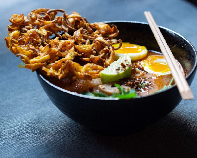 A soup with crispy onions and soft boiled eggs at NYC Burmese restaurant Rangoon.