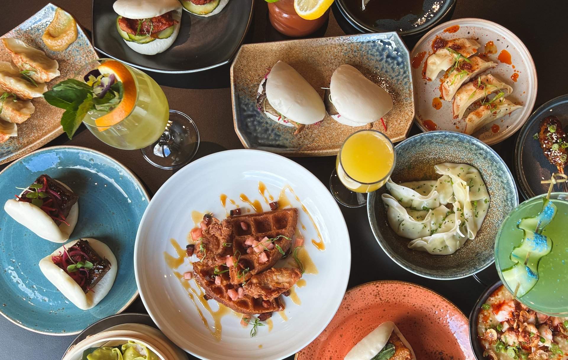 A series of dishes at Nama Ko including waffles, bao, and dumplings