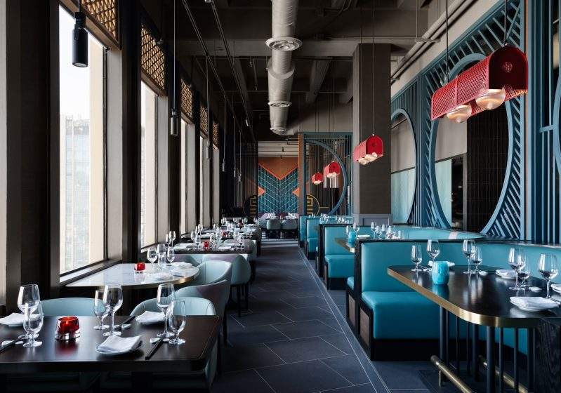 Royal blue sofas and geometric screens at Empress by Boon in San Francisco
