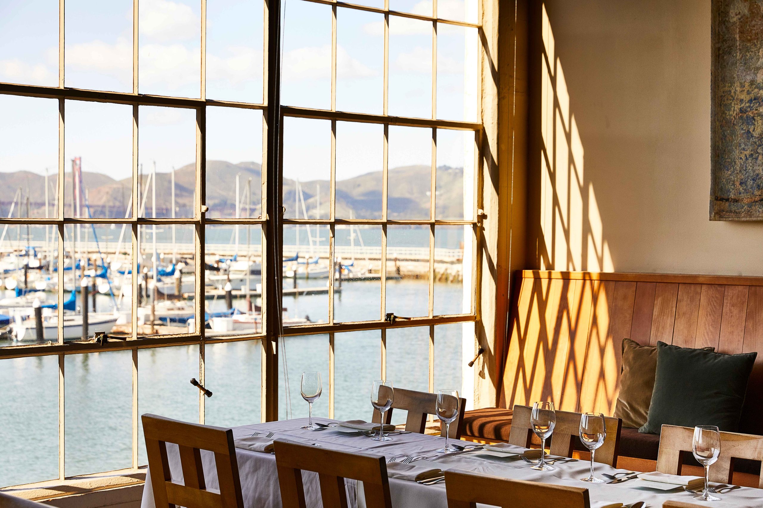 A view of boats in the harbor from a corner table at Greens Restaurant in San Francisco