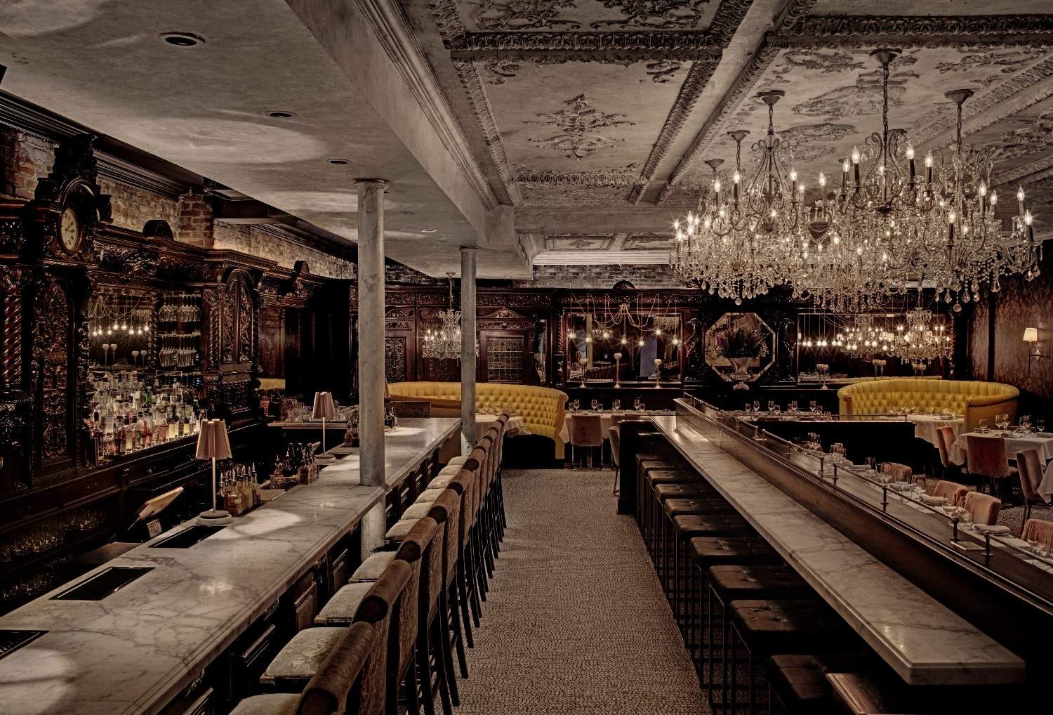 Chandeliers and yellow banquettes at Yvonne’s in Boston