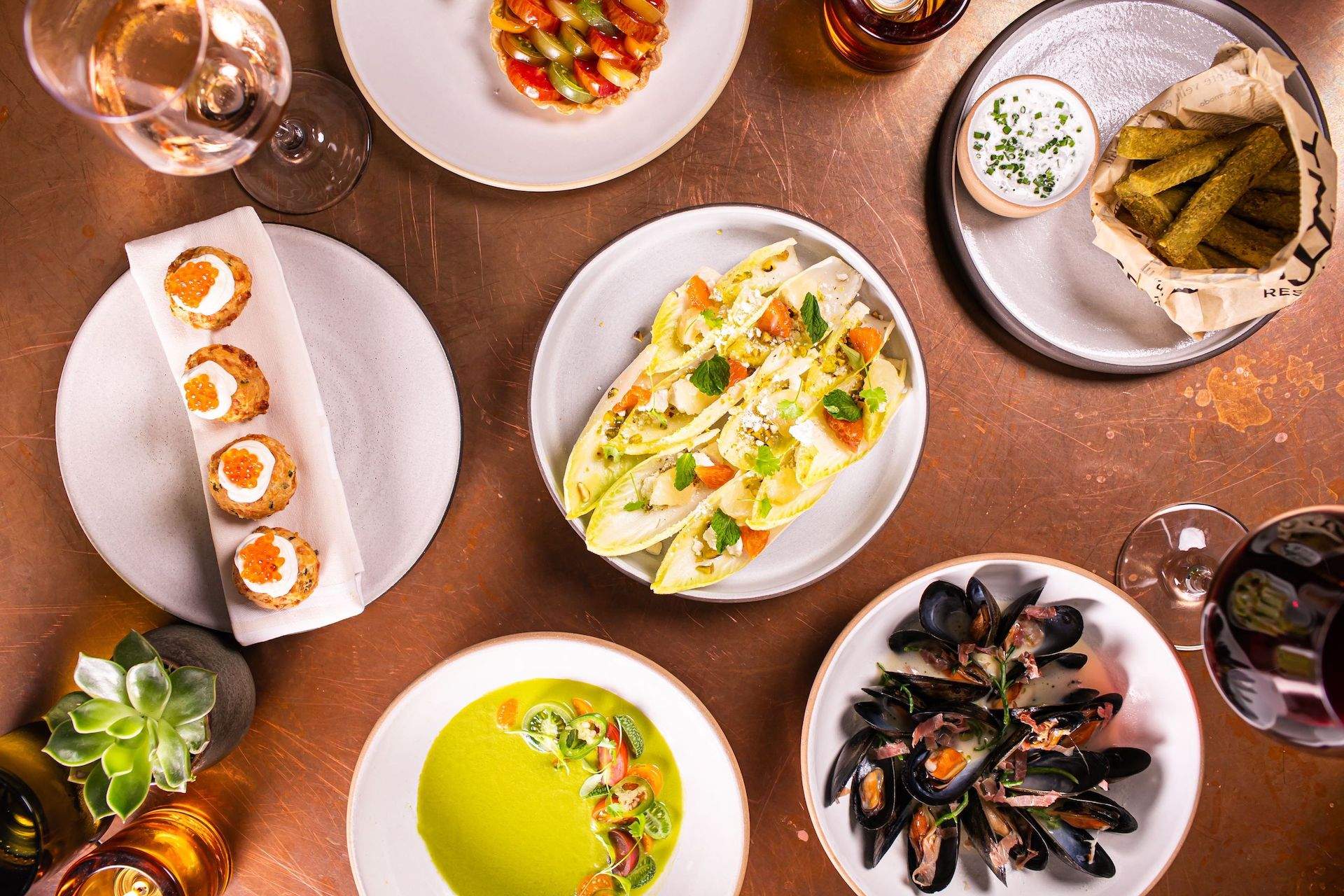 Different sets of white plates with food on it at NYC restaurant Print