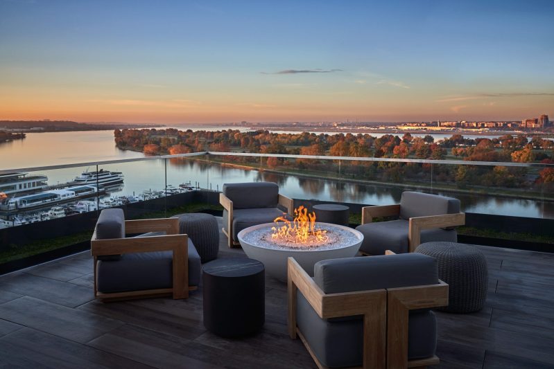 The Potomac River can be seen from the lounge seats that surround a fire pit at the Moonraker in Washington, DC