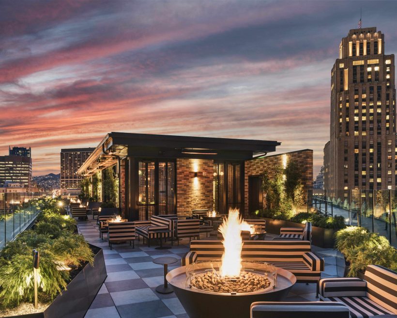 Individual fire pits and striped loungers make up the rooftop seating area at Charmaine’s in San Francisco.