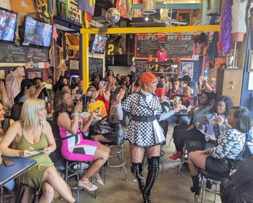 A drag queen performs as people cheer her on from the side at Washington DC bar Nellie’s.