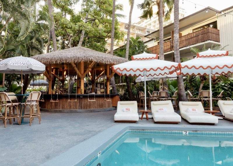 Swing-style seats and poolside chaise lounges at Heyday in Honolulu