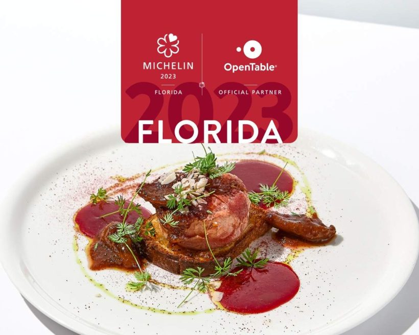 A Michelin logo with a white plate of food showing stake as part of the MICHELIN star announcement in Florida