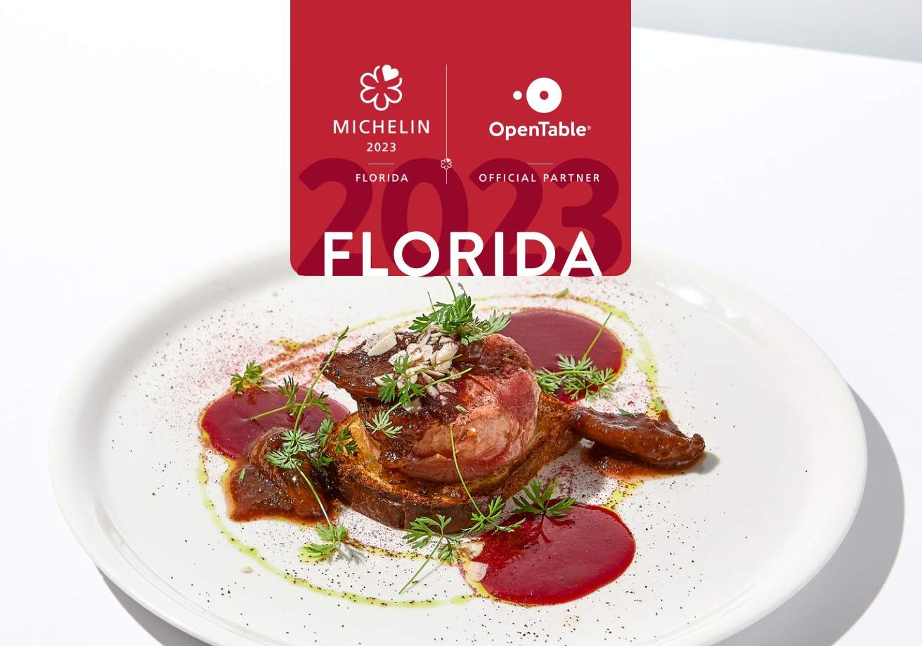 A Michelin logo with a white plate of food showing stake as part of the MICHELIN star announcement in Florida