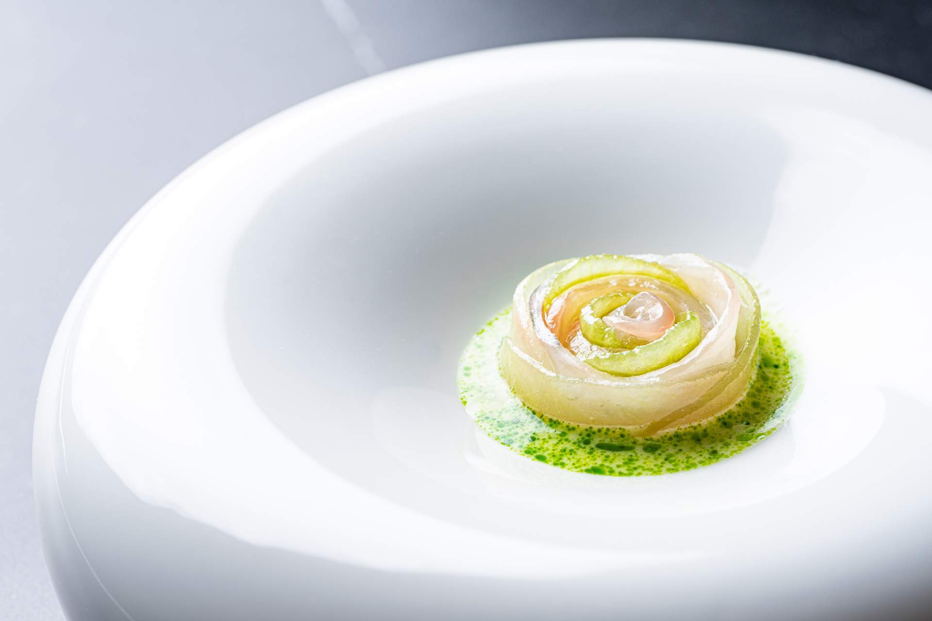 A rose-shaped fish dish with green sauce at San Diego restaurant Addison.
