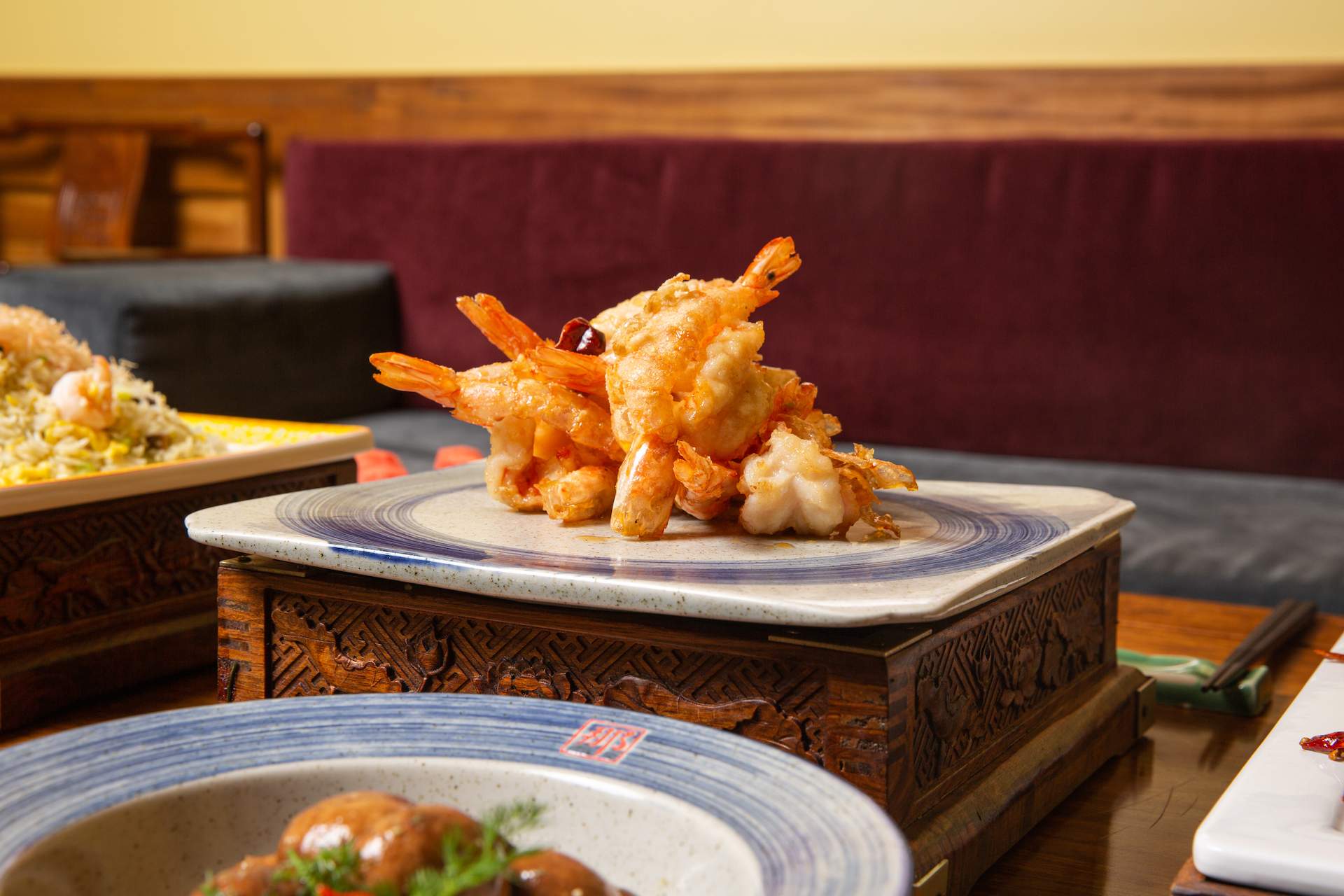 A crispy fried shrimp dish on a table at Temple City restaurant Bistro Na’s.