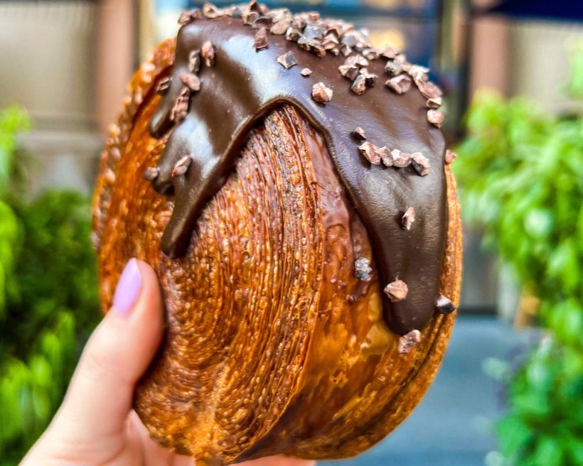 A close up of a spiral croissant from NYC restaurant Lafayette featuring a chocolate glaze.