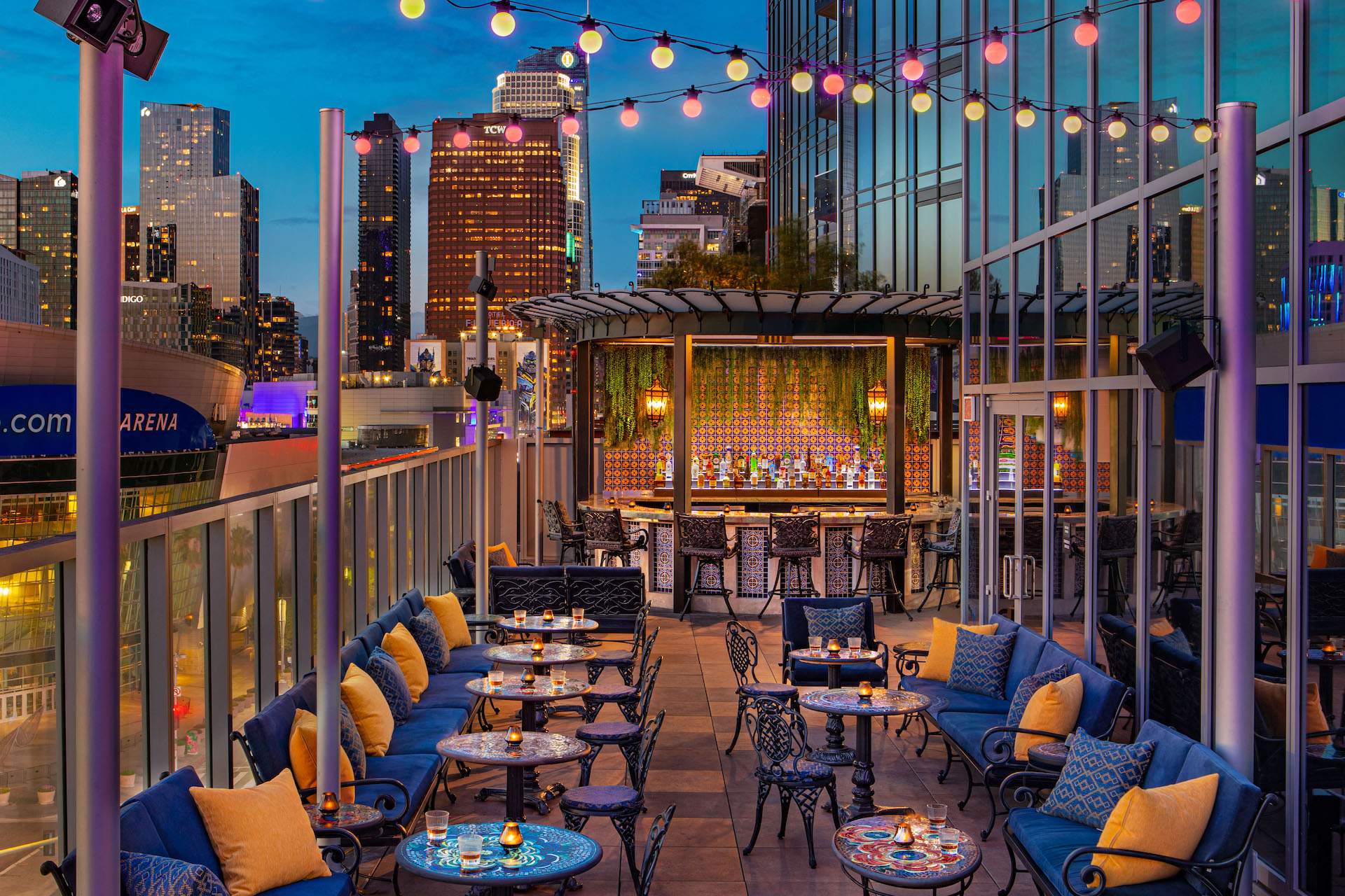The outdoor seating at Los Angeles restaurant Mother of Pearl that looks out onto the Downtown LA skyline