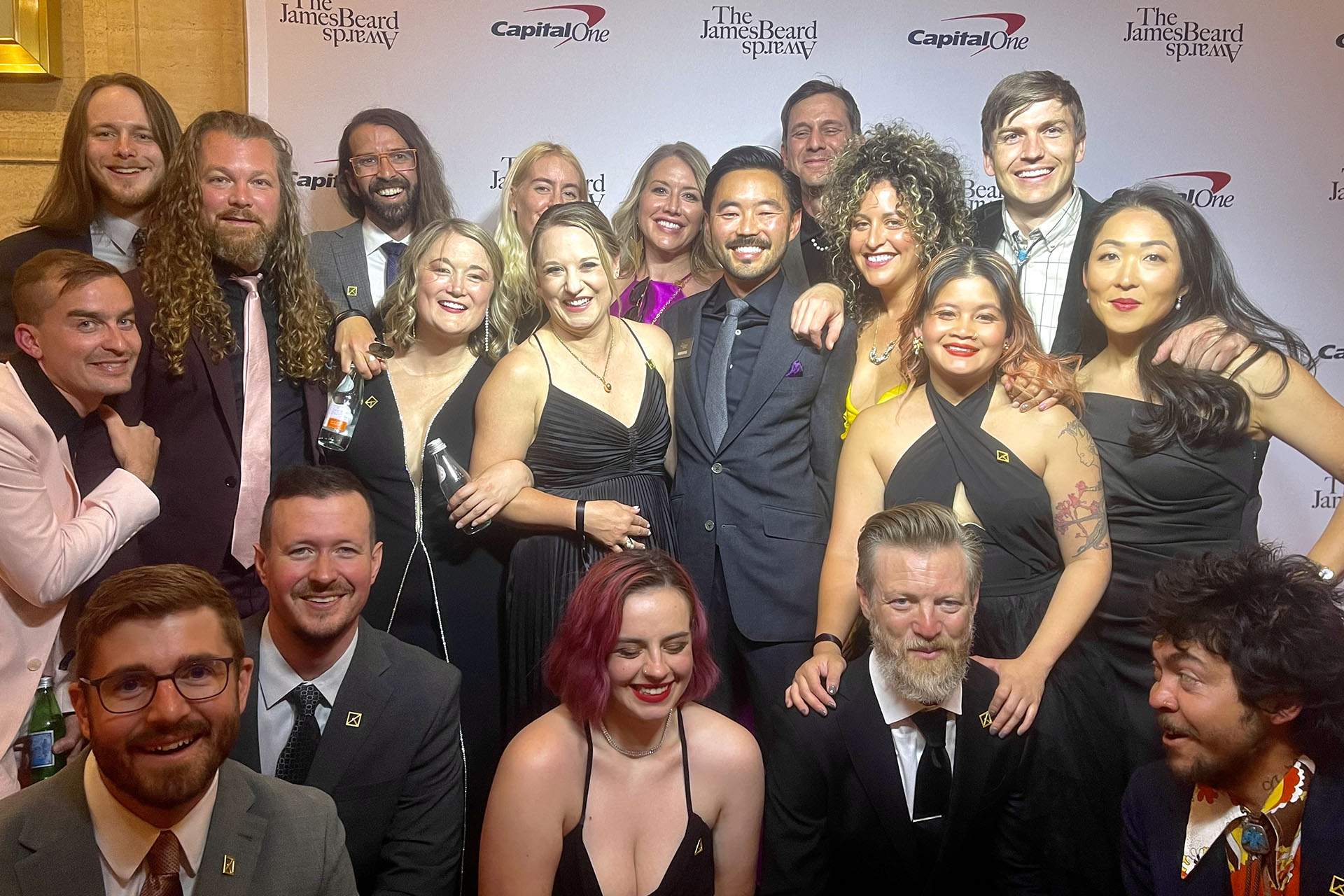 A group of people in black tie gather together for a photo.