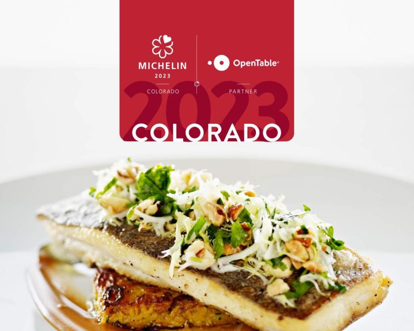 A piece of roasted fish on a white plate with salad on top and a logo that says MICHELIN Colorado