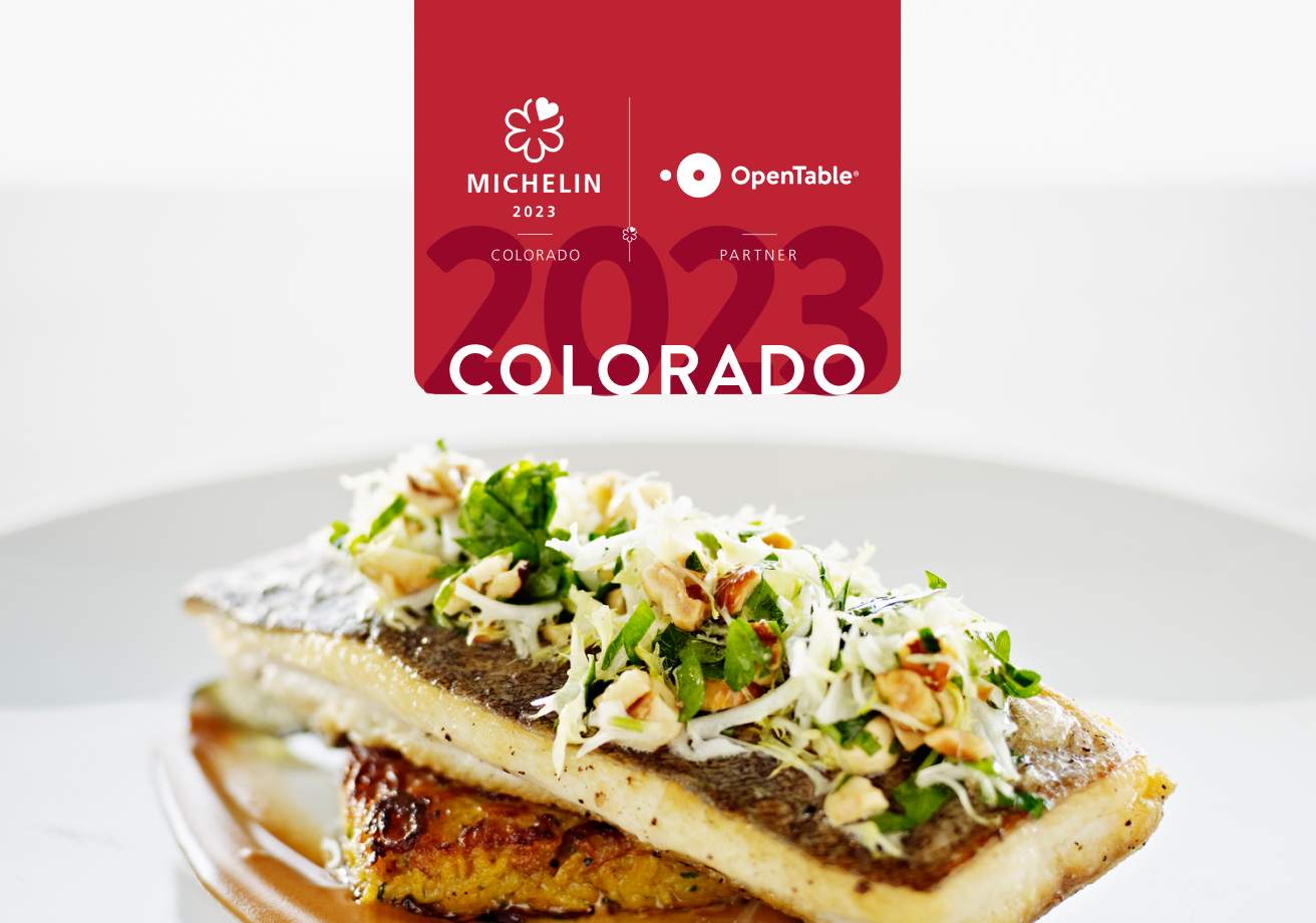 A piece of roasted fish on a white plate with salad on top and a logo that says MICHELIN Colorado