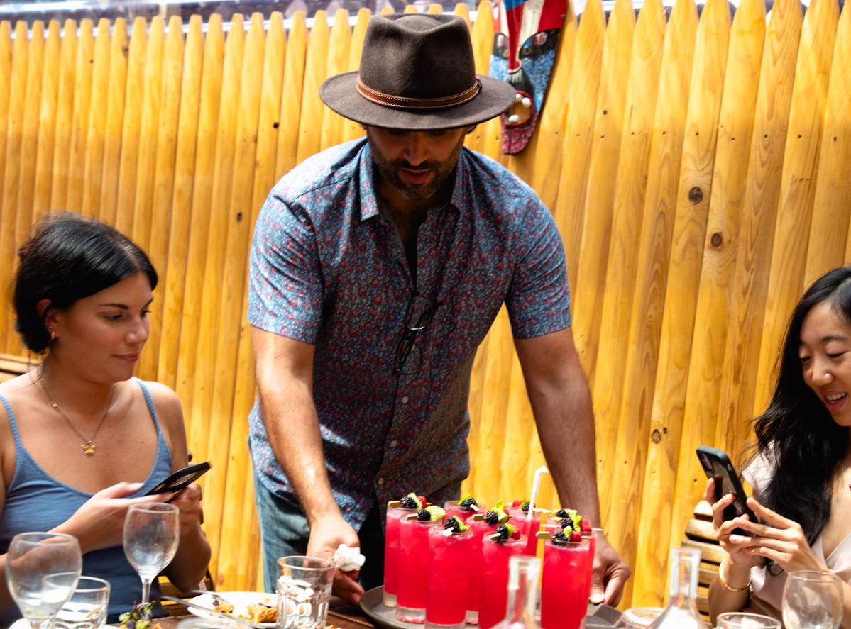 La Fonda owner James Gonzalez serving customers at his East Harlem restaurant