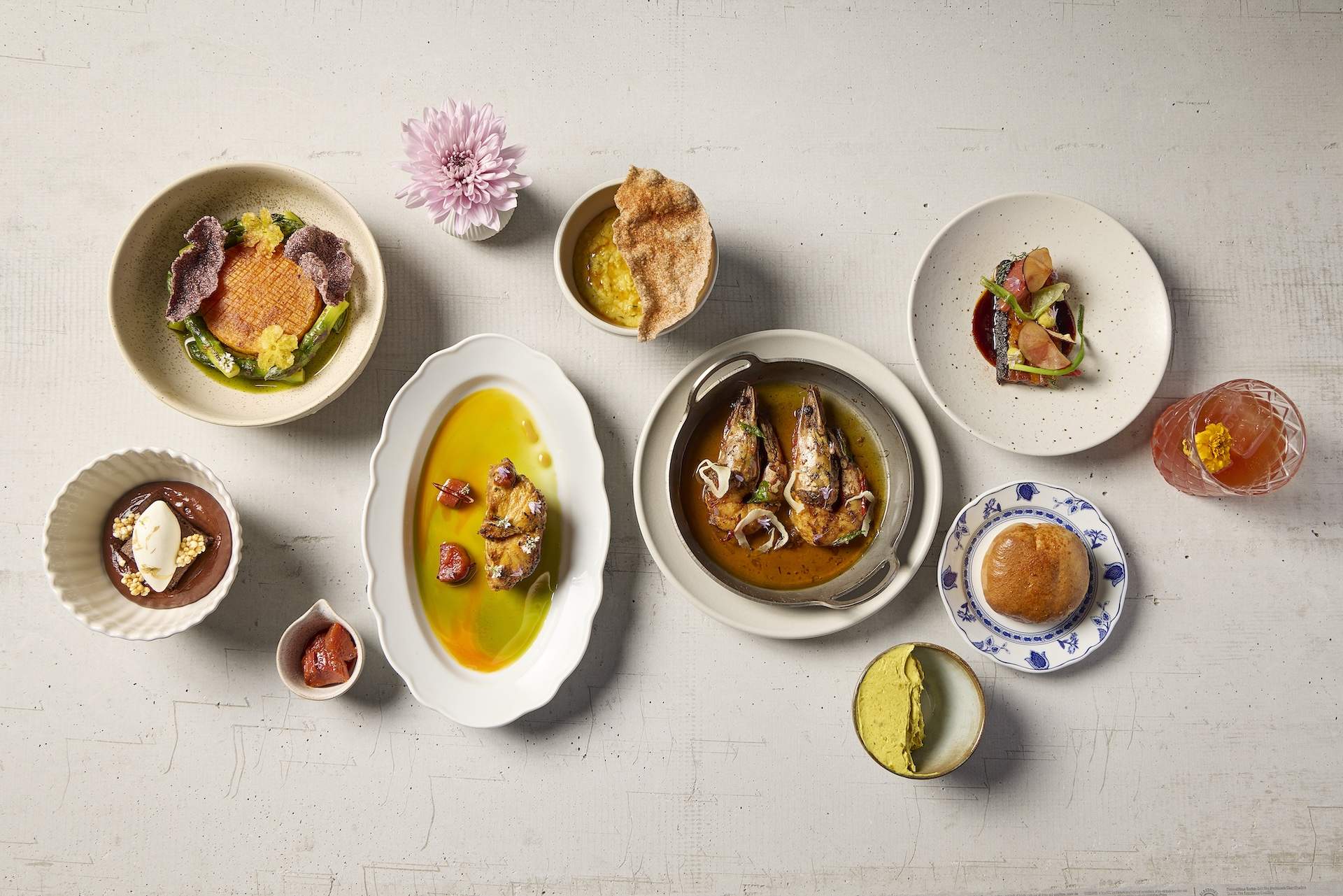 Different plates of food on a white surface at Los Angeles Indian restaurant Baar Baar