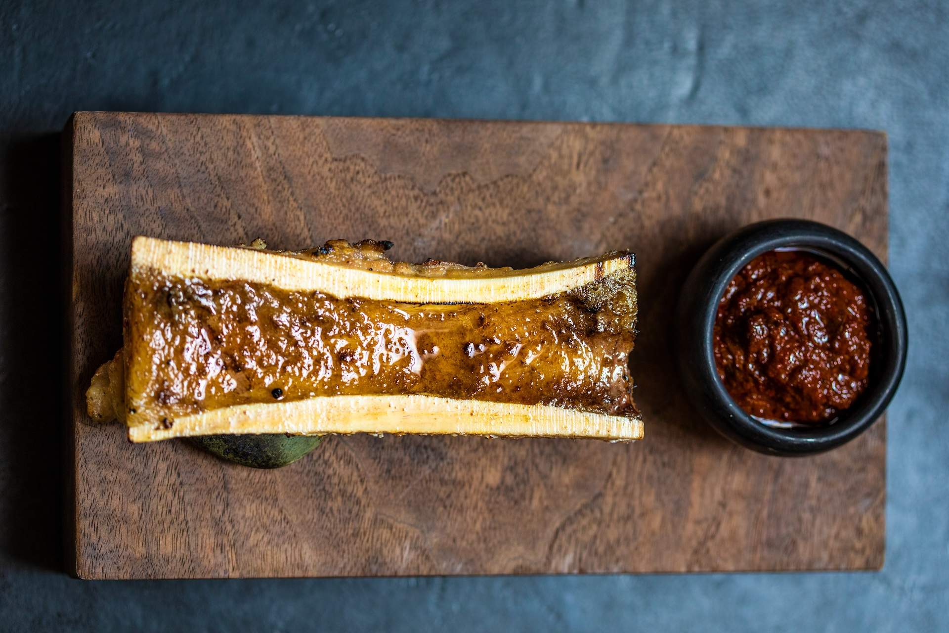A bone marrow dish with a red sauce at Los Angeles restaurant Meteora