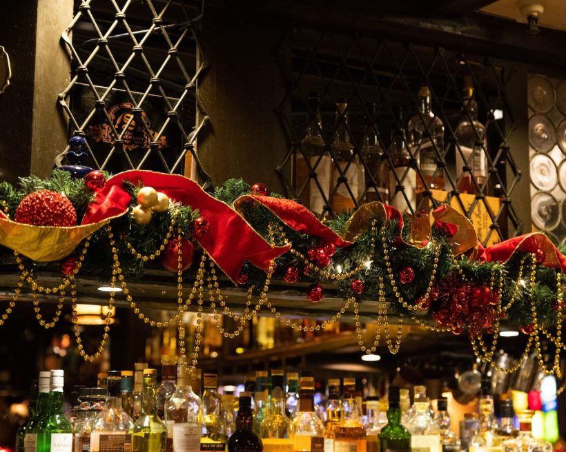 Holiday decor including beads, holly wreaths, and bells at Los Angeles restaurant The Tam O’Shanter