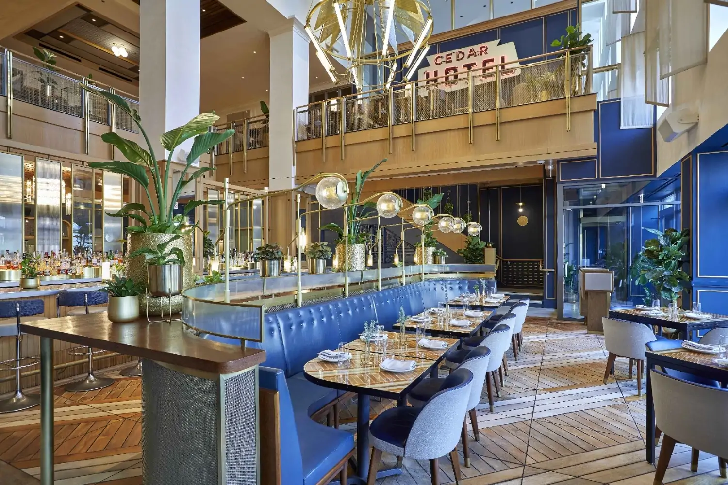 Blue leather banquettes, columns, and a neon sign from its former life as the Cedar Hotel at Somerset in Chicago