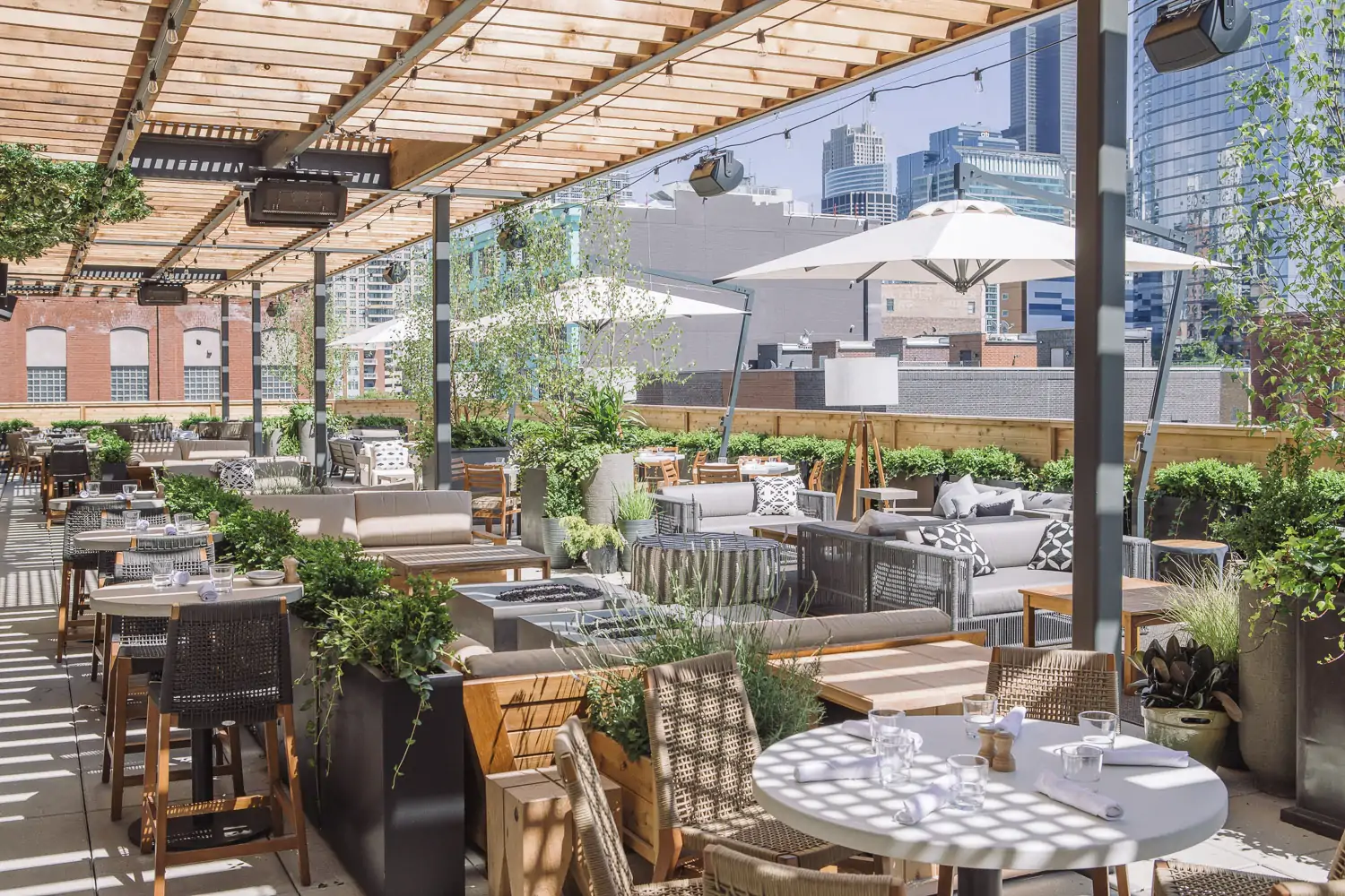 A variety of trees and twinkling lights surround you on the patio at Aba, a Chicago restaurant on OpenTable.
