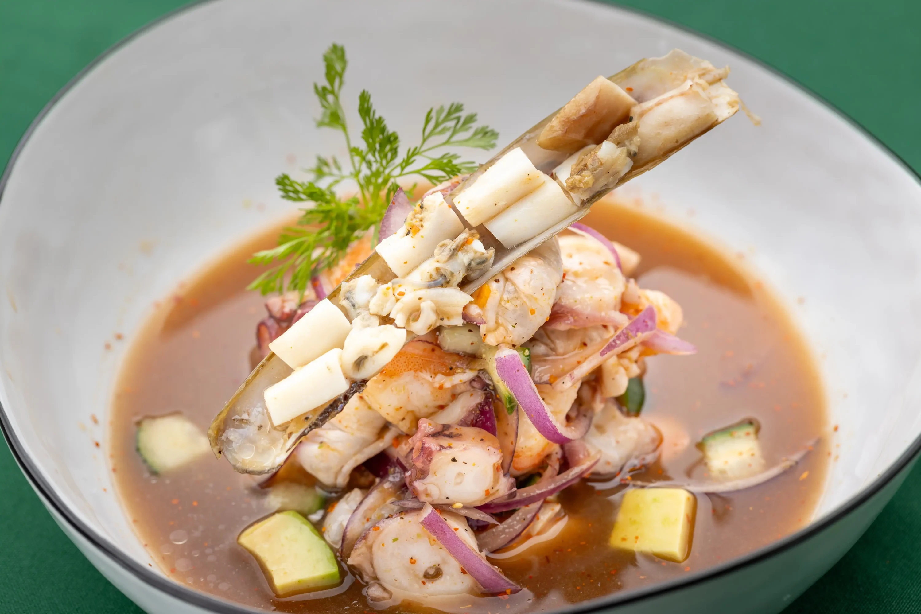 A type of ceviche called aguachile in a white bowl at New York restaurant Casa Bond