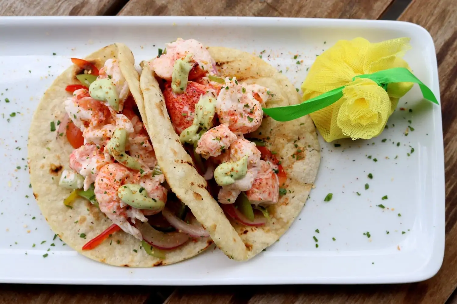Lobster tacos on a white plate at Jonathan’s The Rub in Houston. Book on OpenTable.