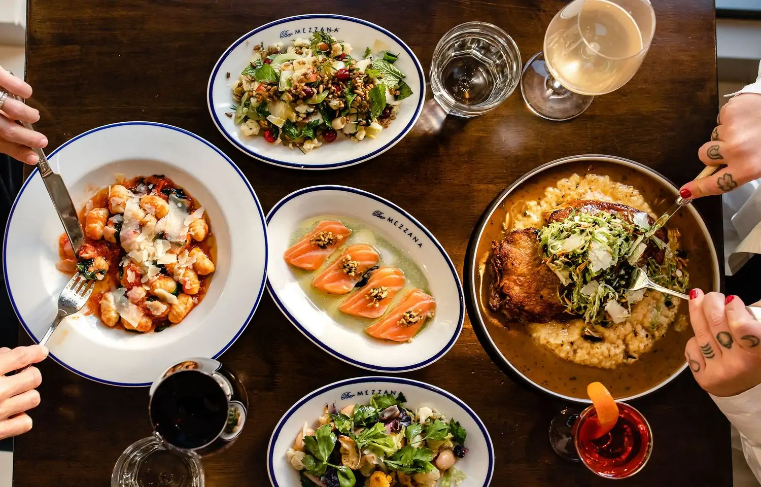 Platters of crudo, housemade pasta, salad, and other Italian dishes at Bar Mezzana in Boston. Available on OpenTable.