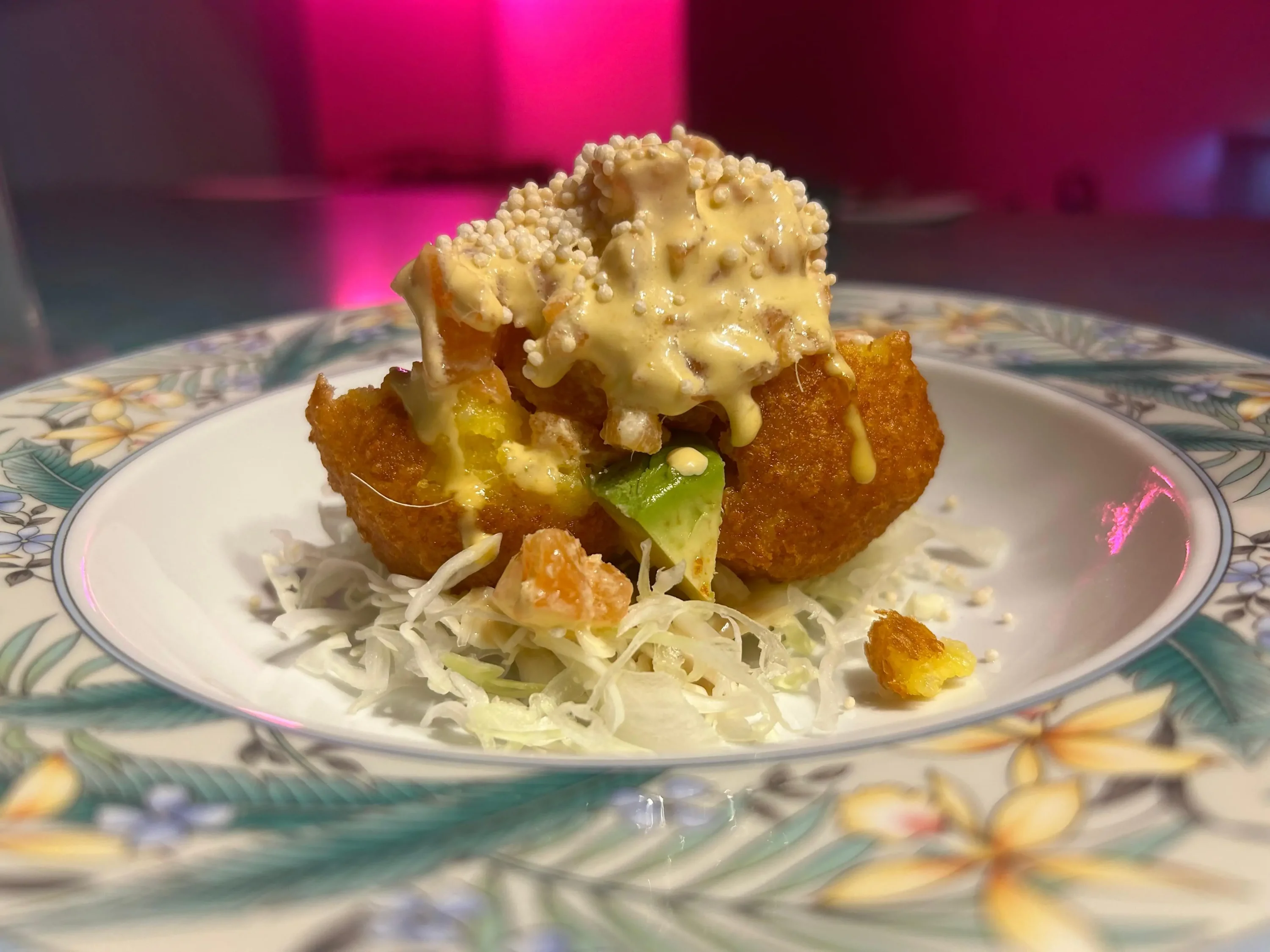 A fried potato dish with a cheesy yellow sauce at Los Angeles restaurant The Hummingbird Ceviche House