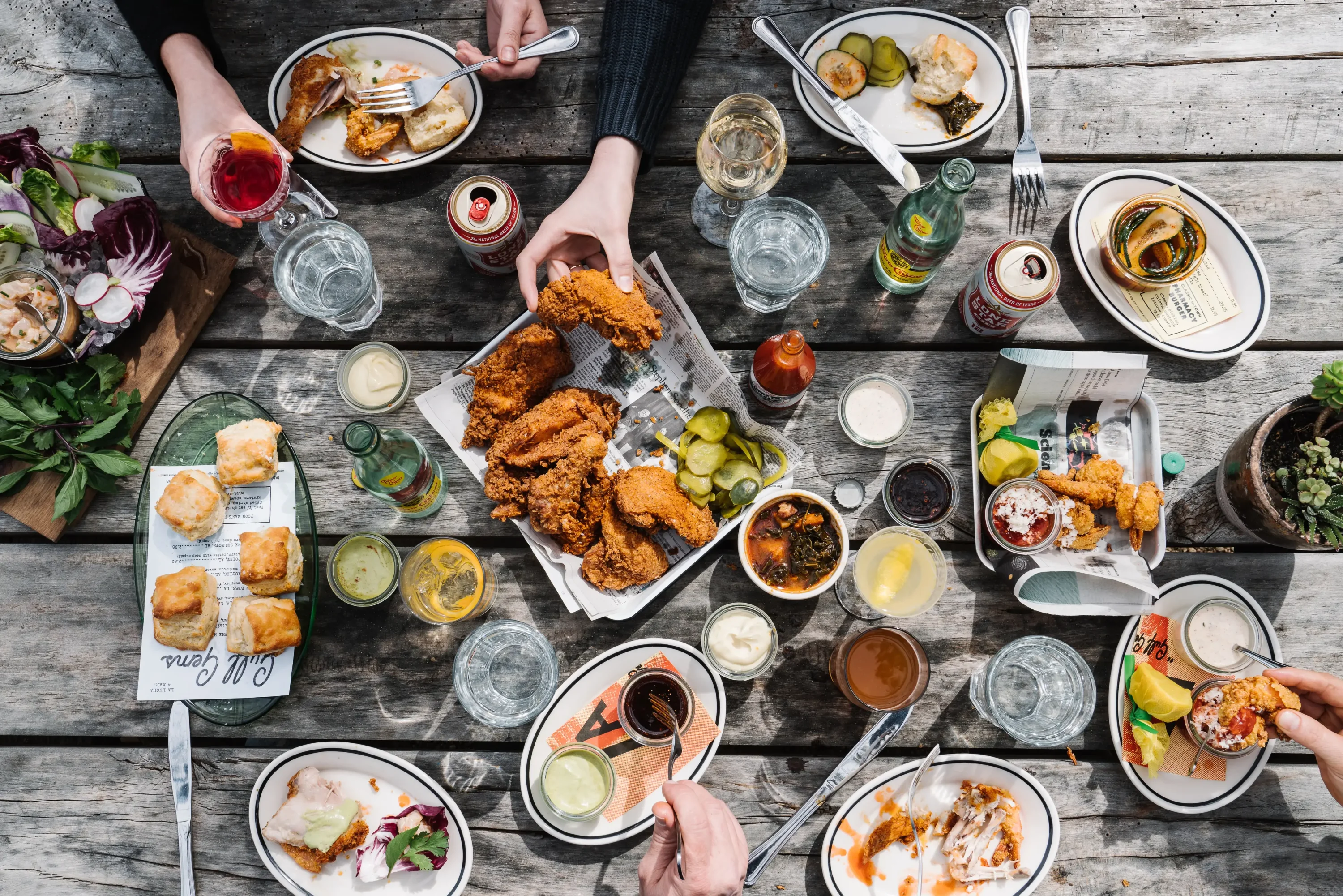 Plates of fried chicken, biscuits, and other comfort food plus cocktails at La Lucha, one of the nice restaurants in Houston. Book on OpenTable.