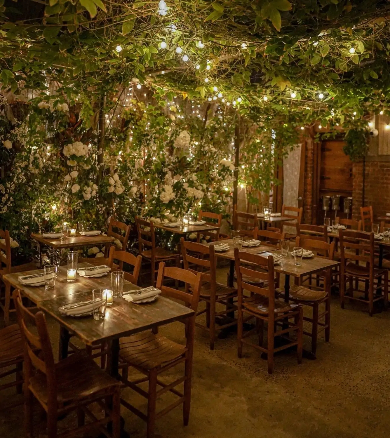 The greenery-strewn garden patio at Palma, one of the best Italian restaurants in New York City. Book on OpenTable.