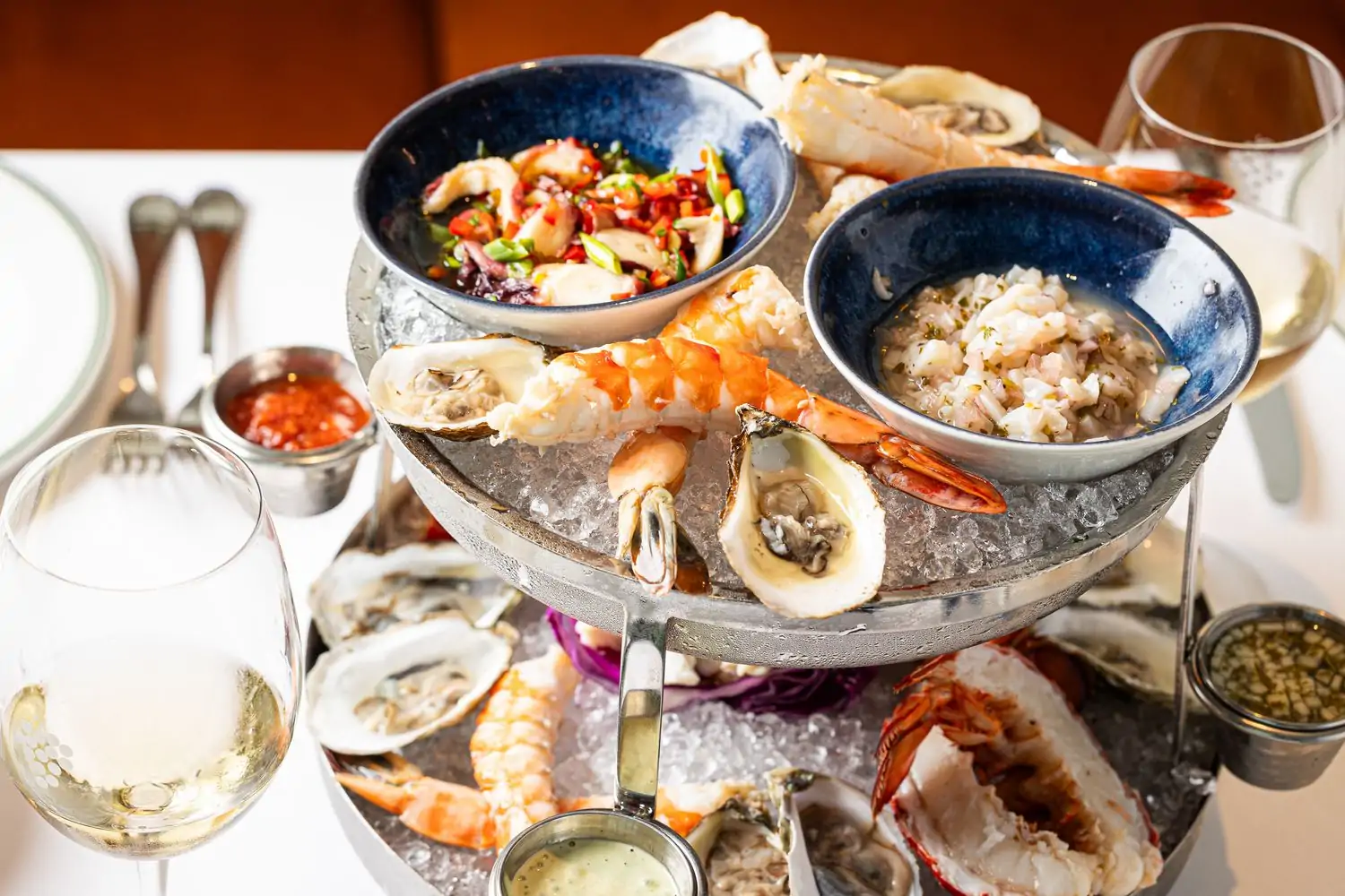 A two-tiered seafood tray with lobster, oysters, ceviche, and more at Smith & Wollensky in Boston. Book on OpenTable.
