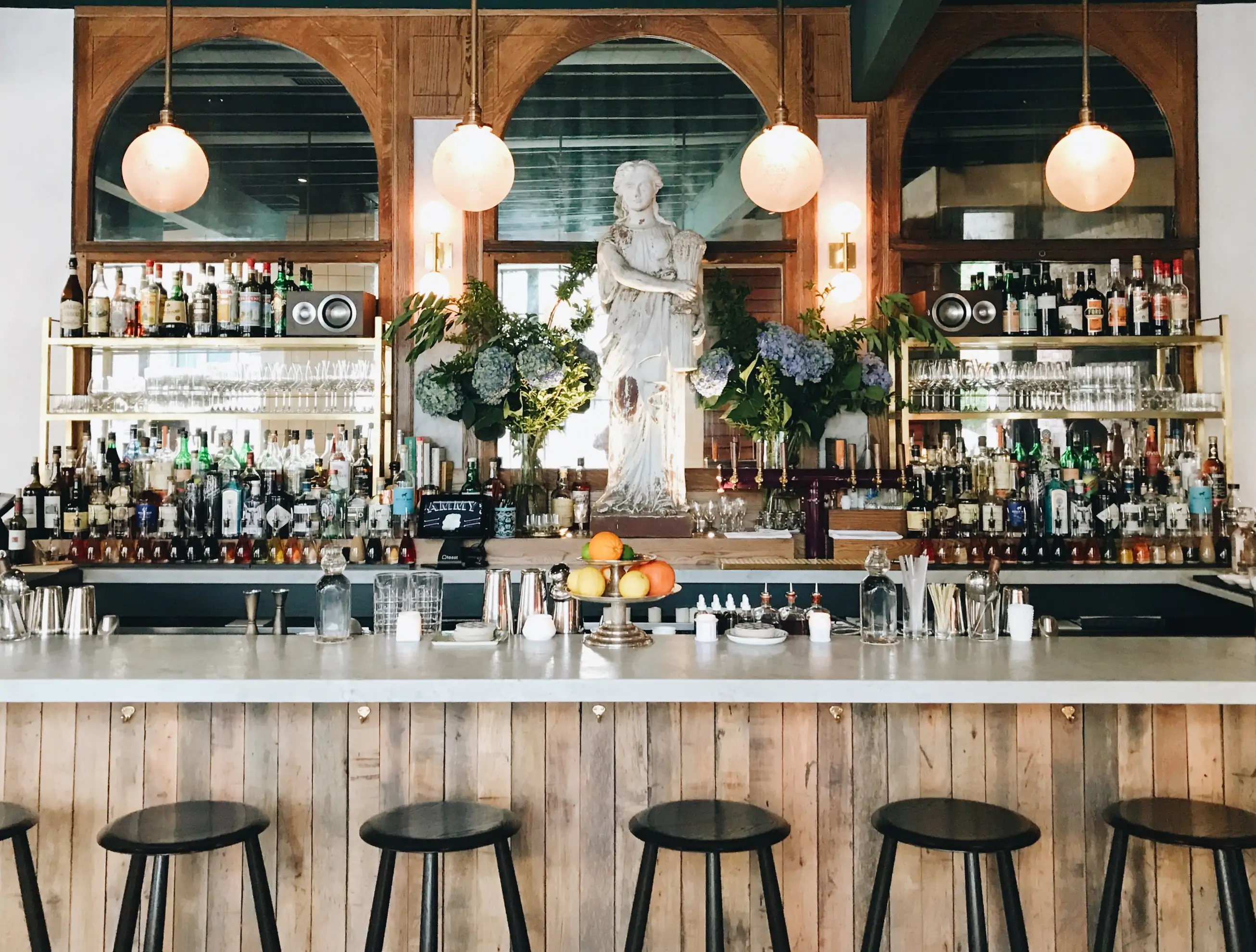 A five-foot-tall statue of Demeter presides over the uncluttered white bar with black wooden stools at Pammy's, one of the best cozy restaurants in Boston on OpenTable.