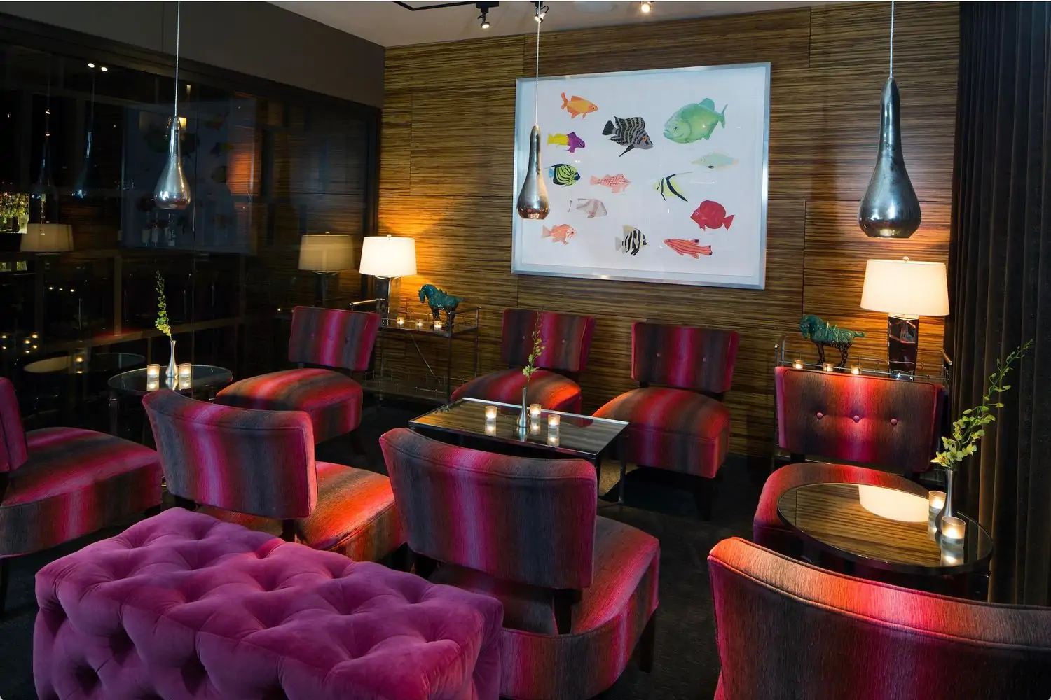 Lounge furniture striped in purple, red, and gray with a painting of colorful fish at Shinsei Restaurant, one of the best cozy restaurants in Dallas, on OpenTable.