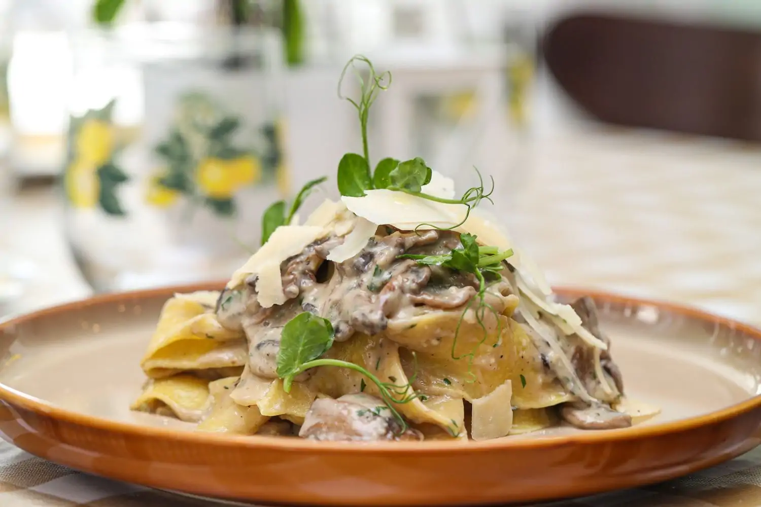 A ceramic plate with pappardelle and mixed mushrooms in a white truffle cream sauce at Limoncello, one of the best Italian restaurants in Miami, on OpenTable.