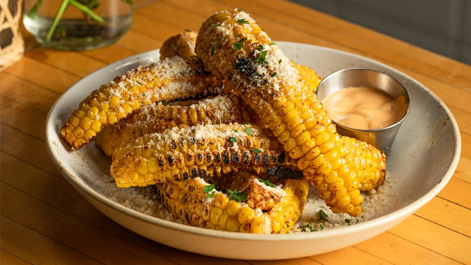 Rows of corn sheared off the cob are dusted with cheese in this dish at OpenTable Restaurant The Butcher's Daughter, a notable vegetarian restaurant Venice Beach, Los Angeles has to offer.