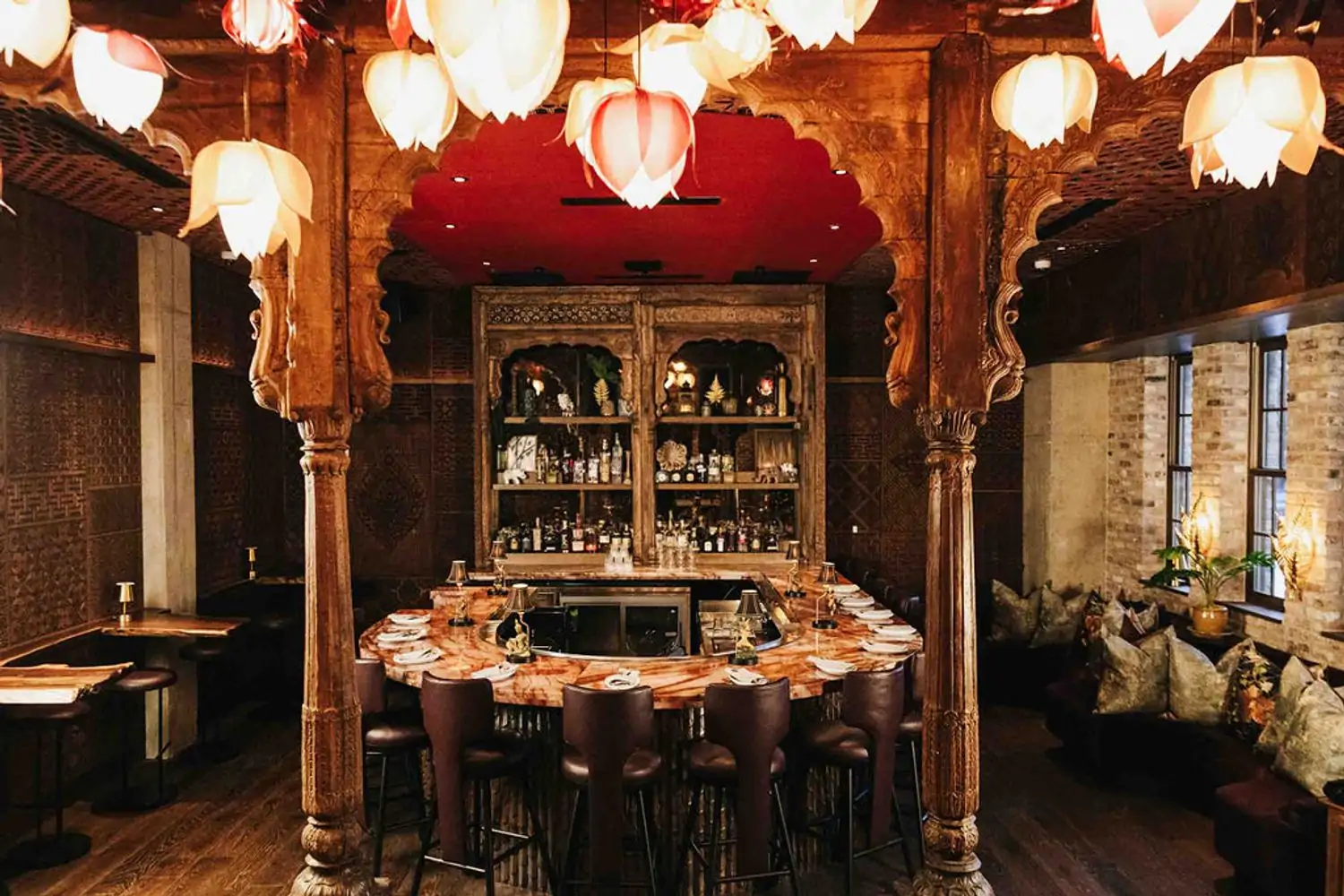 A polished stone bar beneath lotus-shaped lanterns at Elephant East, one of the best cozy restaurants in Dallas on OpenTable.