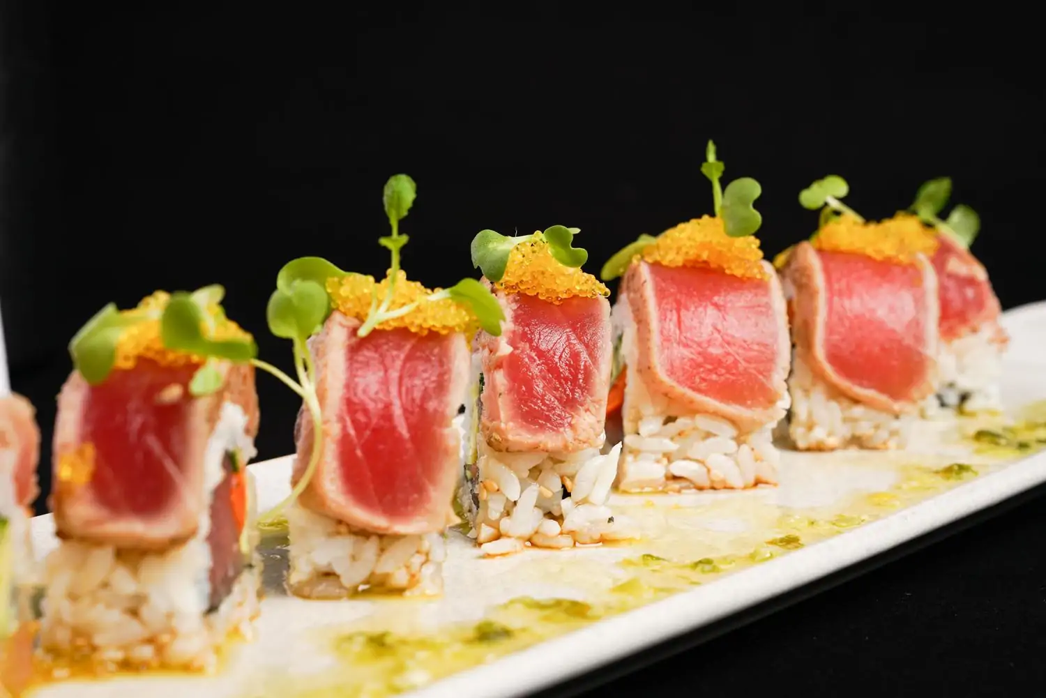A sushi handroll topped with seared tuna, fish eggs, and leafy garnishes at Water Grill in Los Angeles, a restaurant available on OpenTable.