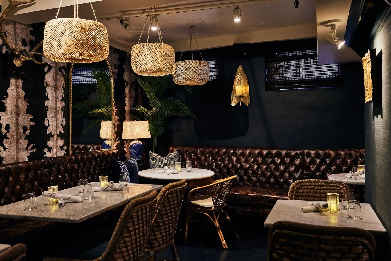 An intimate corner reveals padded leather seats, a round marble-topped table, a rectangular table, and a square table at 1928 Beacon Hill, one of the best cozy restaurants in Boston on OpenTable.