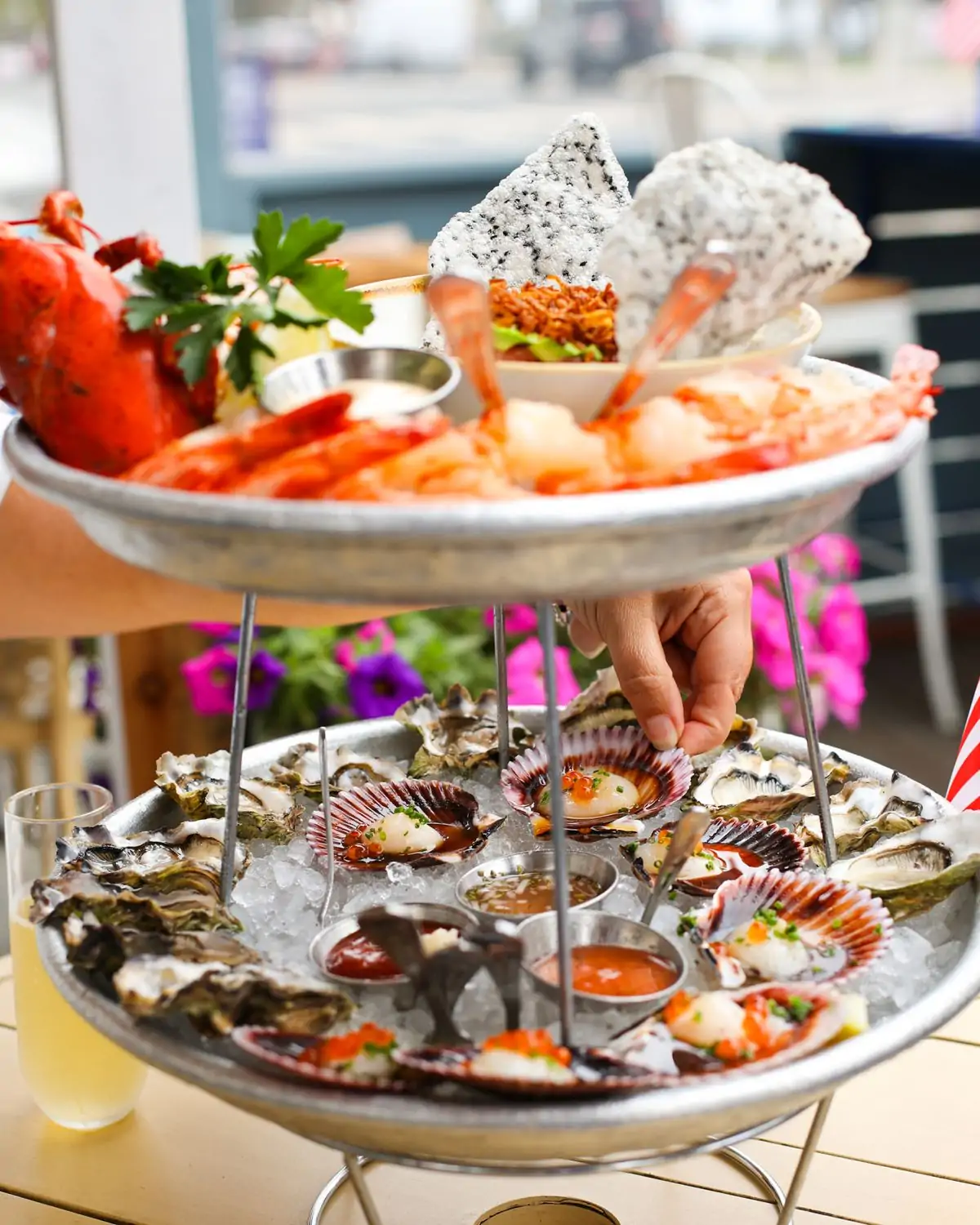 A two-tiered seafood platter with shrimp and dressed oysters at Blue Plate Oysterette in LA. Book on OpenTable.