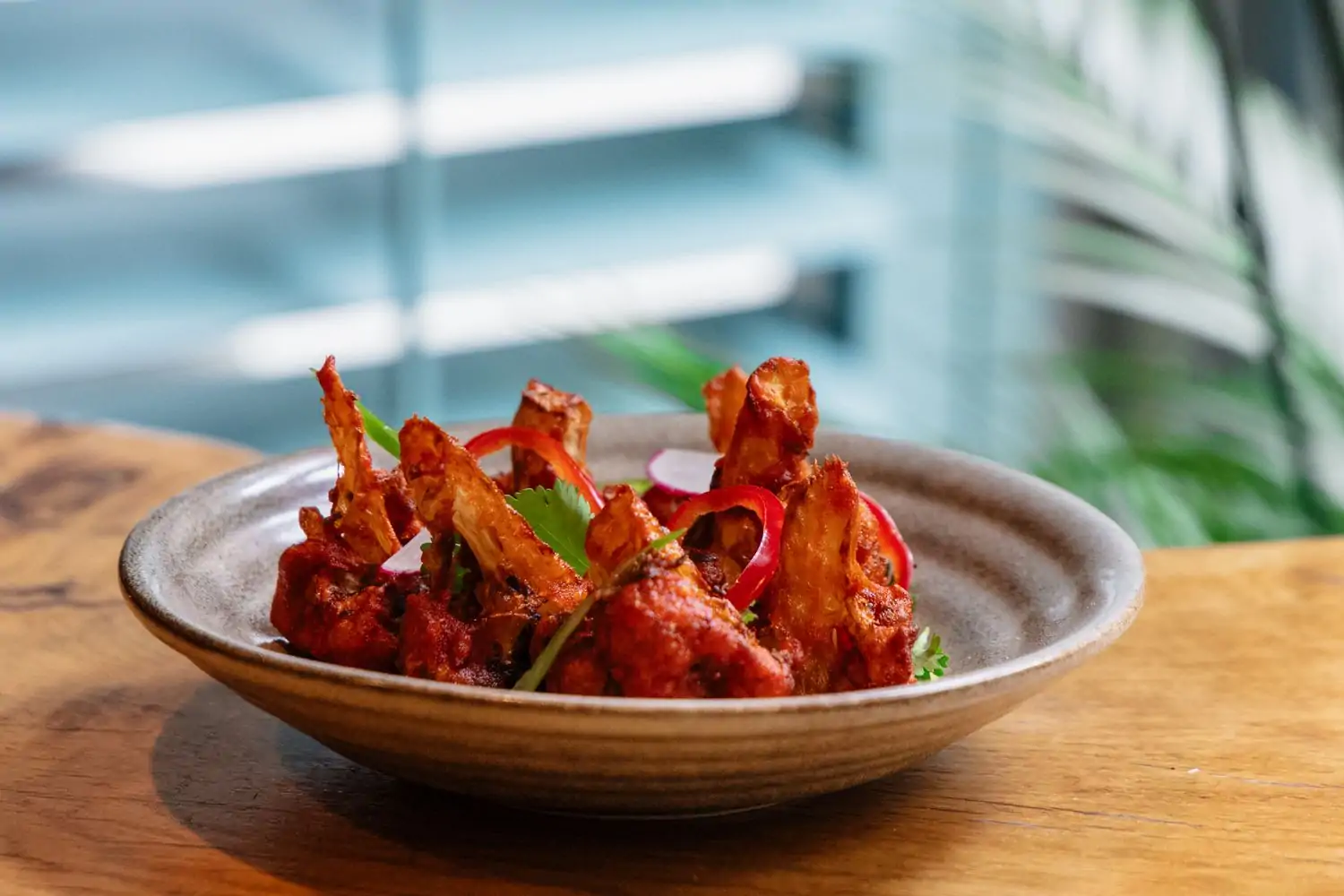 A dish with golden fried chicken wings with coriander at Bar Goa, one of the best Indian restaurants in Chicago on OpenTable.