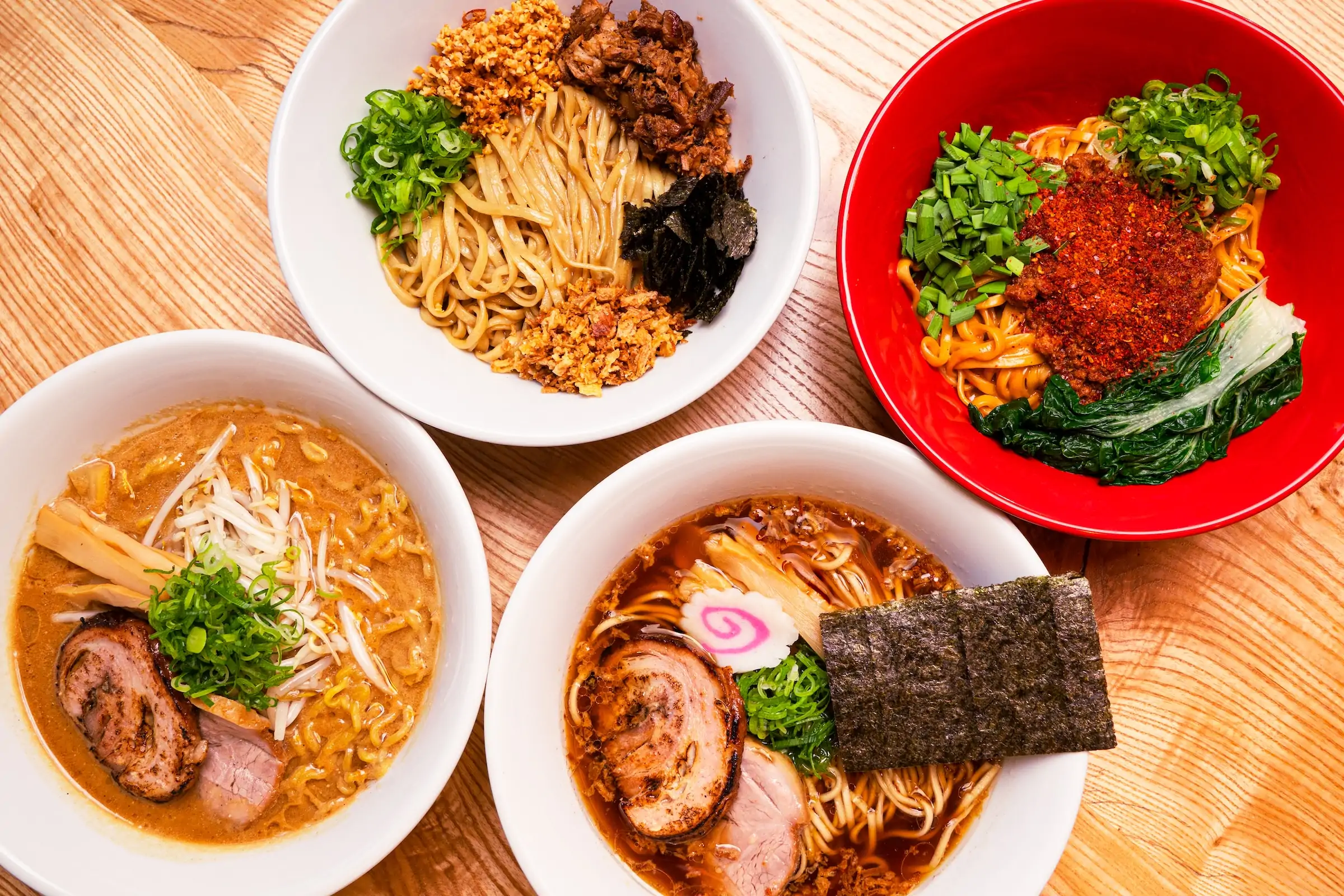 Several bowls of ramen on a wooden table at Chicago restaurant Akahoshi Ramen