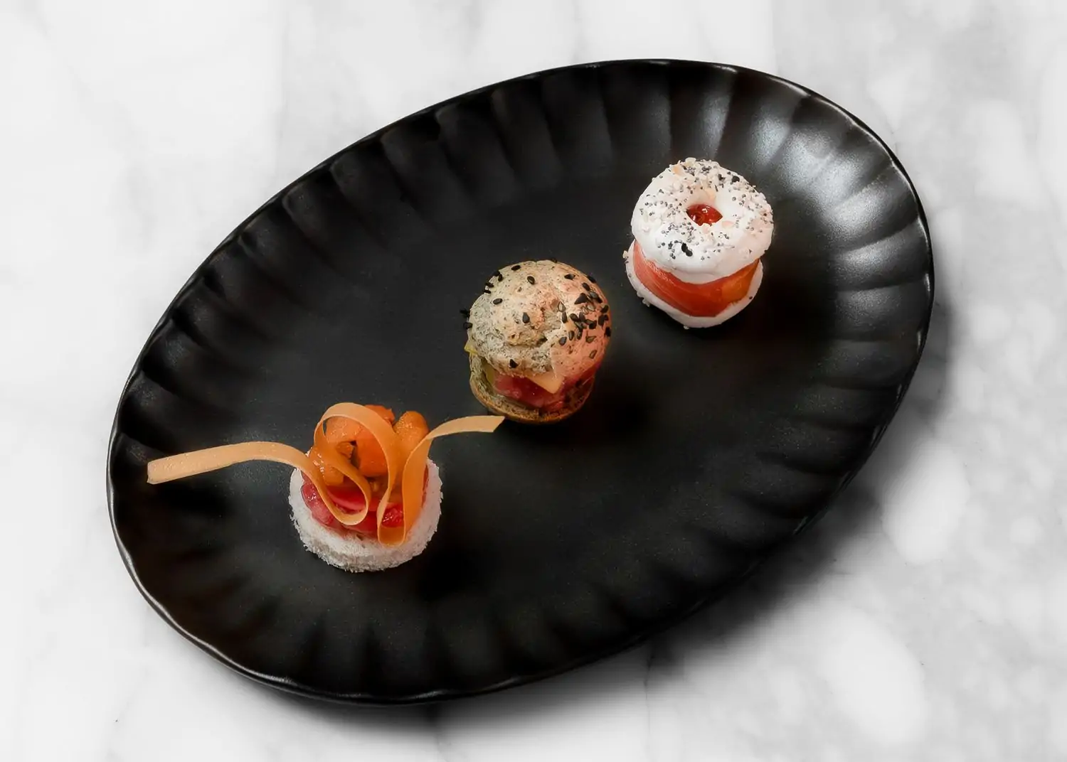 Amuse bouche of a King Salmon everything bagel, Choux a la Otoro, and A5 Wagyu and Hokkaido uni sando at Joomak in NYC. Book on OpenTable.